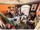 Cluttered bonus room with orange accent wall, motorcycle themed decor and carpet at 6231 Oak Limb Ct, Indianapolis, IN 46221
