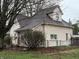 Rear view of home with light colored siding, brown roof and partially fenced in yard at 658 Chestnut St, Noblesville, IN 46060