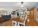 Open-concept dining area featuring hardwood floors, modern light fixtures, and seamless transition to the living room and kitchen at 6640 S New Jersey St, Indianapolis, IN 46227