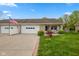 Inviting ranch style home with brick accents, an attached garage and meticulously kept front lawn at 6640 S New Jersey St, Indianapolis, IN 46227