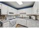 Charming kitchen with white cabinets, granite countertops, and a gas range at 6640 S New Jersey St, Indianapolis, IN 46227