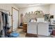 Practical laundry room equipped with a washer, dryer, and storage shelves, ensuring efficiency and organization at 6640 S New Jersey St, Indianapolis, IN 46227