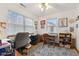 Inviting office space with natural light, featuring a ceiling fan, neutral walls, and a mix of carpet and hardwood flooring at 6640 S New Jersey St, Indianapolis, IN 46227