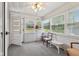 Bright sunroom with ample natural light, neutral color scheme, and view of the outdoors at 6640 S New Jersey St, Indianapolis, IN 46227