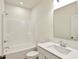 Well-lit bathroom with a shower-tub combo and a modern white vanity at 7136 Jackson Dr, Cumberland, IN 46229