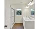 Bathroom features a dual sink vanity, shower with glass door, and bright natural light from a window at 7136 Jackson Dr, Cumberland, IN 46229