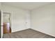 An empty bedroom with neutral carpet and paint, featuring a closet and an adjacent room at 7136 Jackson Dr, Cumberland, IN 46229