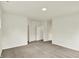 A carpeted bedroom with neutral walls and two doorways providing access to other rooms at 7136 Jackson Dr, Cumberland, IN 46229