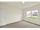Neutral bedroom with carpet, natural light from the window, and a minimal design at 7136 Jackson Dr, Cumberland, IN 46229