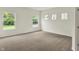 Well-lit bedroom with carpet and multiple windows, enhanced by natural light at 7136 Jackson Dr, Cumberland, IN 46229