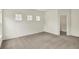 A carpeted bedroom has an open closet and three windows which let in plenty of natural light at 7136 Jackson Dr, Cumberland, IN 46229
