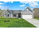 Charming single-Gathering home featuring stone accents and a two-car garage at 7136 Jackson Dr, Cumberland, IN 46229