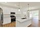 Contemporary kitchen with island, pendant lighting, stainless appliances, and bright white cabinetry at 7136 Jackson Dr, Cumberland, IN 46229