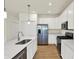 Modern kitchen with stainless steel appliances, white cabinets, and a center island at 7136 Jackson Dr, Cumberland, IN 46229