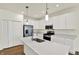 Modern kitchen with stainless steel appliances, white cabinets, and a center island at 7136 Jackson Dr, Cumberland, IN 46229