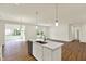 Modern kitchen with stainless steel appliances, island, white cabinets, and an open floorplan at 7136 Jackson Dr, Cumberland, IN 46229