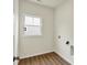 A well-lit laundry room with hookups and a window at 7136 Jackson Dr, Cumberland, IN 46229
