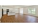 Bright open-concept living room and kitchen with hardwood floors at 7136 Jackson Dr, Cumberland, IN 46229