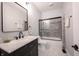 Elegant bathroom featuring a marble vanity, glass shower, and modern fixtures, exuding sophistication at 722 E Minnesota St, Indianapolis, IN 46203