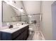 Modern bathroom features double sink vanity and glass shower with stone tile floor at 722 E Minnesota St, Indianapolis, IN 46203