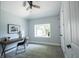 Cozy bedroom with a wooden desk, ceiling fan, and a bright window offering natural light at 722 E Minnesota St, Indianapolis, IN 46203