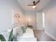 Cozy bedroom featuring a daybed with decorative pillows, ceiling fan, and a modern light fixture at 722 E Minnesota St, Indianapolis, IN 46203