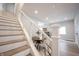 Staircase leading to a dining area and kitchen, showcasing an open layout and modern design elements at 722 E Minnesota St, Indianapolis, IN 46203