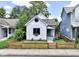 Charming single-story home with a freshly painted exterior and a beautifully landscaped front yard with a wooden fence at 722 E Minnesota St, Indianapolis, IN 46203