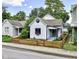 Street view of a charming home with a fresh exterior, complemented by mature trees and a well-maintained front yard at 722 E Minnesota St, Indianapolis, IN 46203
