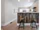 Interior featuring a stylish kitchen bar with wooden stools, complemented by modern countertops and stainless steel appliances at 722 E Minnesota St, Indianapolis, IN 46203