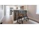 Beautiful kitchen bar with seating, stainless steel refrigerator and open shelving at 722 E Minnesota St, Indianapolis, IN 46203