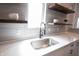 Close-up of a modern kitchen sink with stainless steel faucet and marble countertops with floating shelves at 722 E Minnesota St, Indianapolis, IN 46203