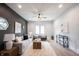 Spacious living room with a neutral palette, stylish seating, and a ceiling fan for added comfort at 722 E Minnesota St, Indianapolis, IN 46203