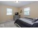 This bedroom features a neutral color scheme and natural lighting from two windows, complemented by a TV at 7546 Lindenwood Dr, Indianapolis, IN 46227