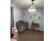 A cozy Bedroom features a crib, play kitchen, toy storage, and a delightful beaded chandelier at 7546 Lindenwood Dr, Indianapolis, IN 46227