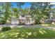 Charming two-story home with a brick facade, attached garage and a beautifully landscaped front yard at 7546 Lindenwood Dr, Indianapolis, IN 46227