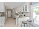 Bright kitchen with white cabinets, granite countertops, and a tiled backsplash at 7546 Lindenwood Dr, Indianapolis, IN 46227