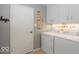 Well-lit laundry room with modern appliances and ample storage space at 7546 Lindenwood Dr, Indianapolis, IN 46227