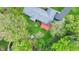 Aerial view of a home with a spacious backyard and a red deck with outdoor seating at 7804 Wawasee Dr, Indianapolis, IN 46250