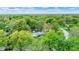 Idyllic property featuring mature trees, well-maintained landscaping, and a charming home with a cozy brick exterior at 7804 Wawasee Dr, Indianapolis, IN 46250