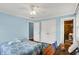 Comfortable bedroom showcasing hardwood floors, a ceiling fan, closet, and an ensuite bathroom at 7804 Wawasee Dr, Indianapolis, IN 46250