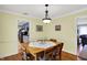 Dining room with a wooden table, neutral wall color, and an open view of kitchen at 7804 Wawasee Dr, Indianapolis, IN 46250
