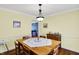 Spacious dining room with hardwood floors, bright walls, and seating for six at 7804 Wawasee Dr, Indianapolis, IN 46250