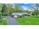 Charming single story home with a well-manicured lawn and attached two car garage at 7804 Wawasee Dr, Indianapolis, IN 46250