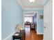 Welcoming foyer with hardwood floors, blue walls, and view of living room, providing a warm first impression at 7804 Wawasee Dr, Indianapolis, IN 46250