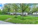 Picturesque home with mature trees framing the lush green lawn and inviting facade at 7804 Wawasee Dr, Indianapolis, IN 46250
