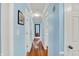 Hallway with hardwood floors and blue walls, connecting various rooms and creating a sense of flow at 7804 Wawasee Dr, Indianapolis, IN 46250