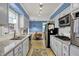 Well-lit kitchen featuring stainless steel appliances, light countertops, and ample cabinet space at 7804 Wawasee Dr, Indianapolis, IN 46250