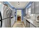 Galley kitchen with granite counters, tiled floor and view into dining area at 7804 Wawasee Dr, Indianapolis, IN 46250