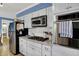 Updated kitchen with stainless appliances, white cabinets, and granite countertops at 7804 Wawasee Dr, Indianapolis, IN 46250